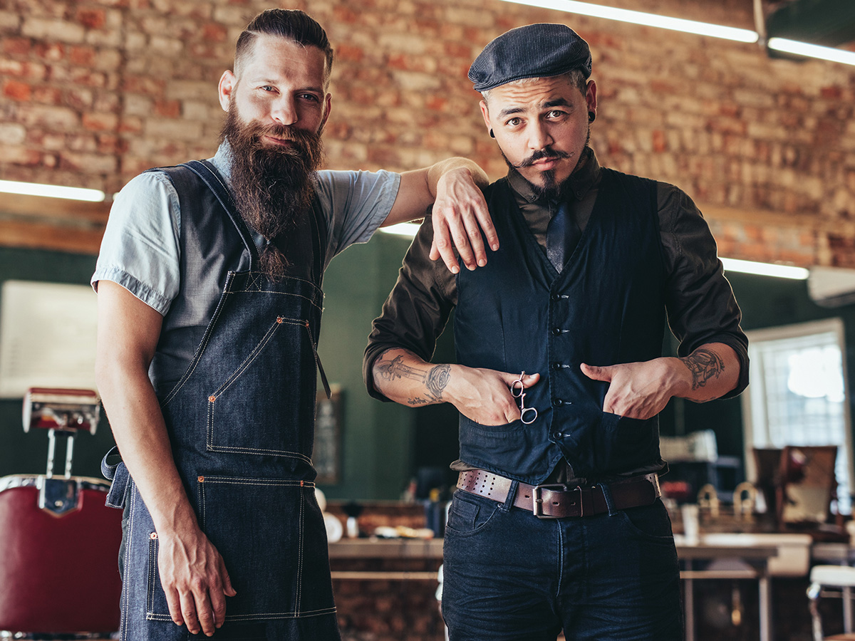 Shot of two stylish men posing together at salon.