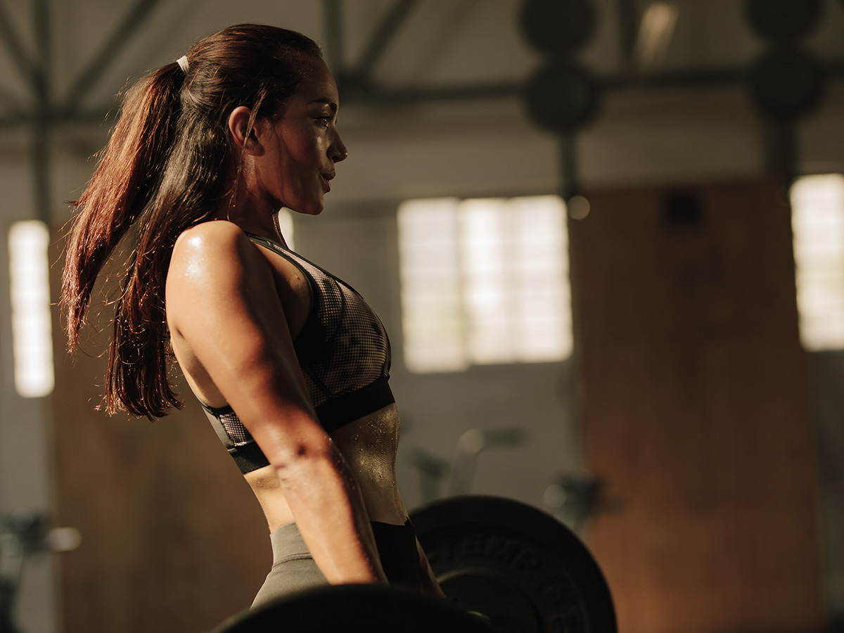 physically fit woman deadlifting