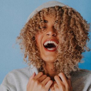 young women with hood pulled up smiling