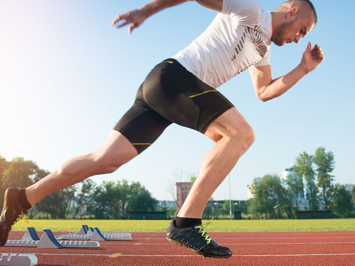 Gentleman running on a track in athletic wear.