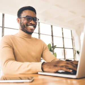 person smiling using computer