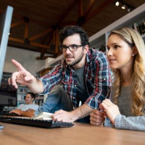 two people looking at a computer