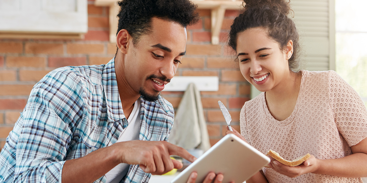 image of a couple looking at an ipad