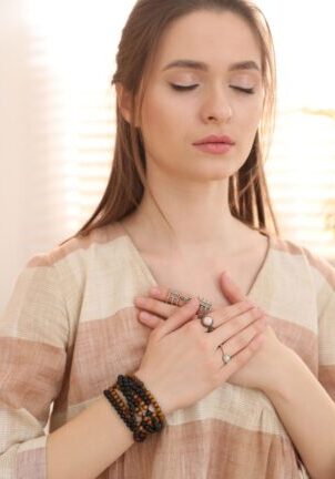 woman with hands rested on chest